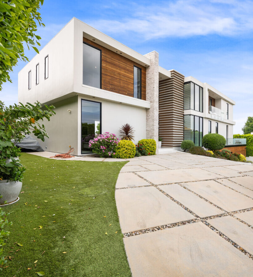 A Driveway of a contemporary house with a garden area